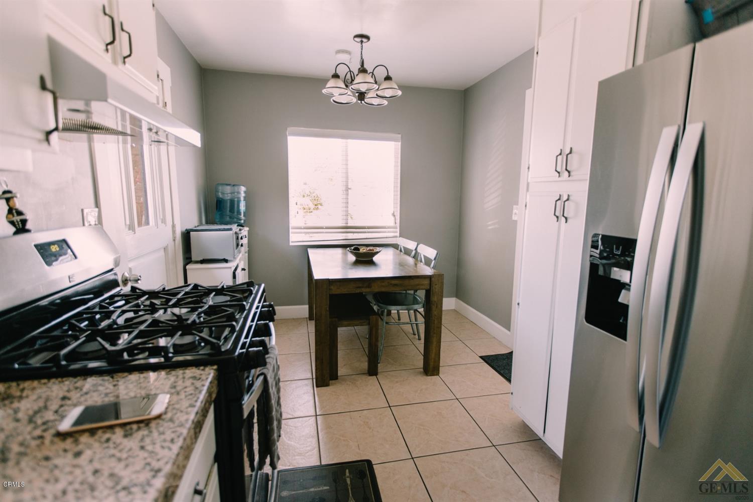 424 West Cedar Street Oxnard, CA 93033 - Photo 10 of 26 a kitchen with stainless steel appliances a stove a refrigerator and a counter