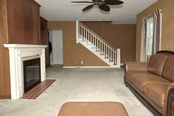 a living room with furniture and a fireplace