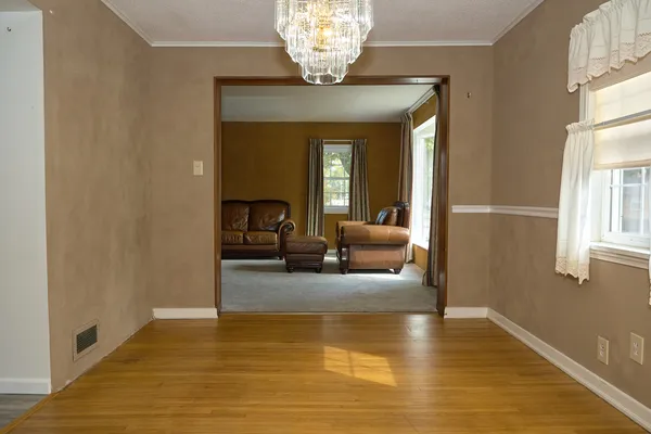 a view of living room with furniture and a chandelier