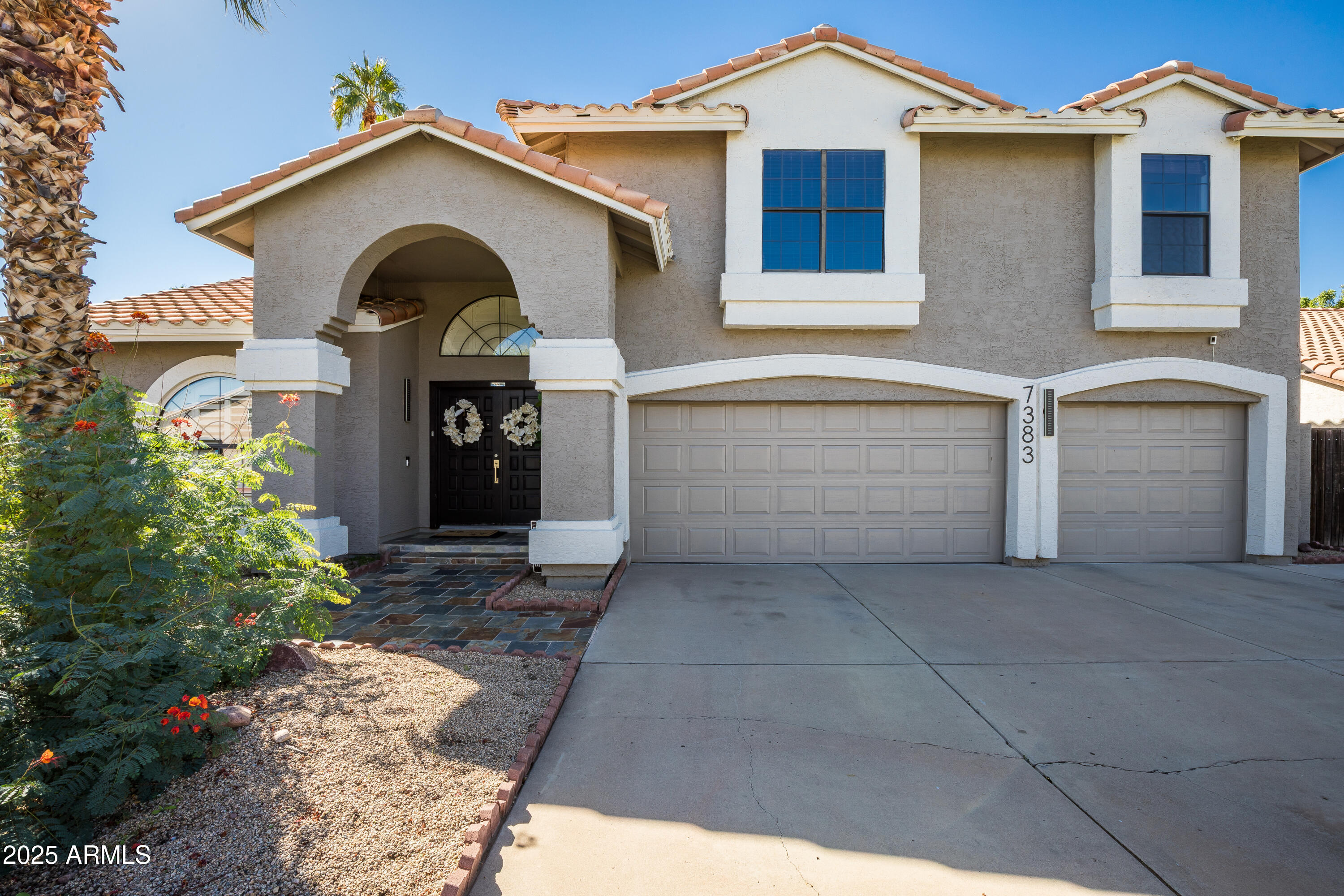 a front view of a house with a garage