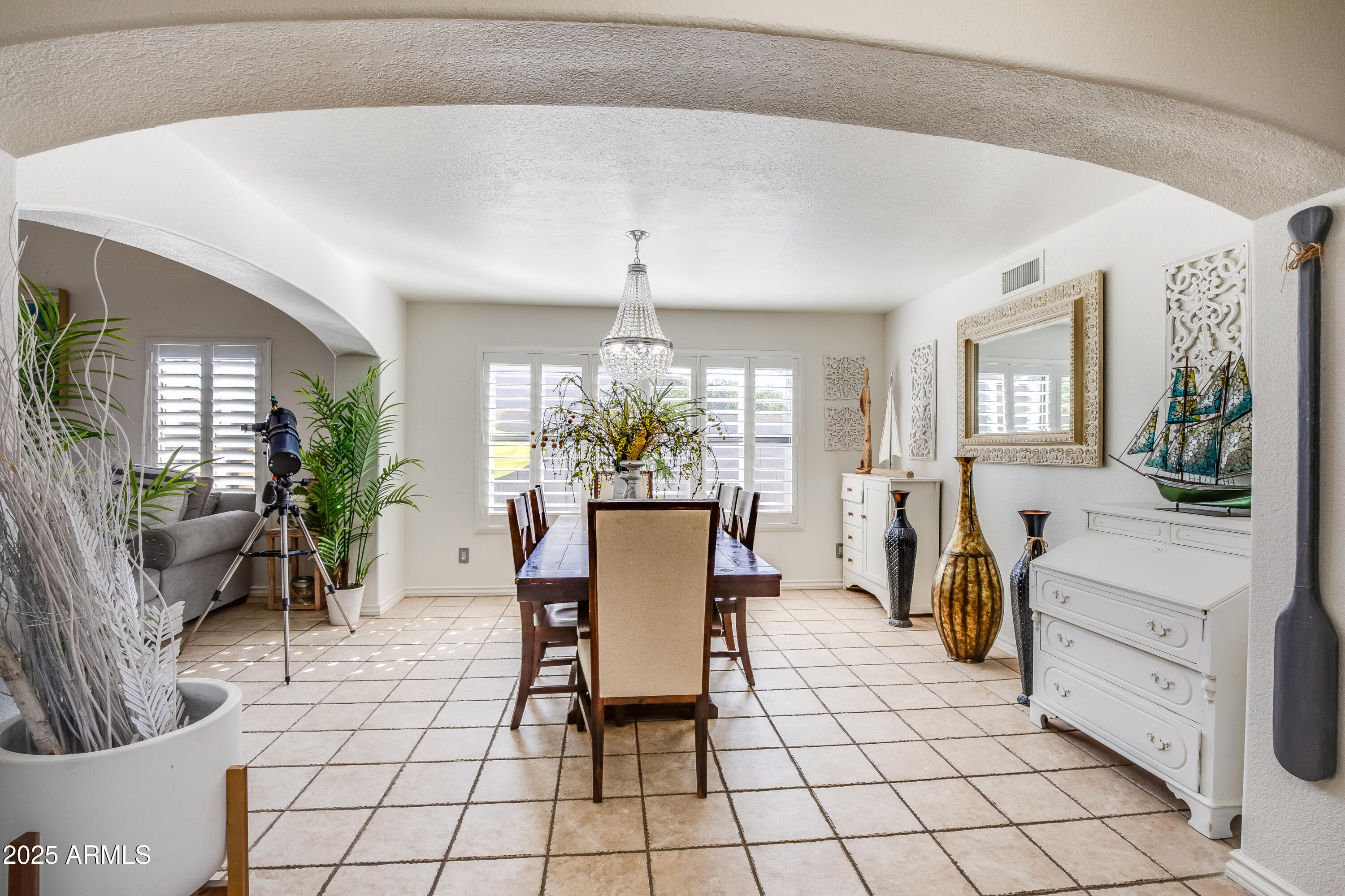 7383 West Utopia Road Glendale, AZ 85308 - Photo 7 of 18 a living room with furniture a dining table and large windows