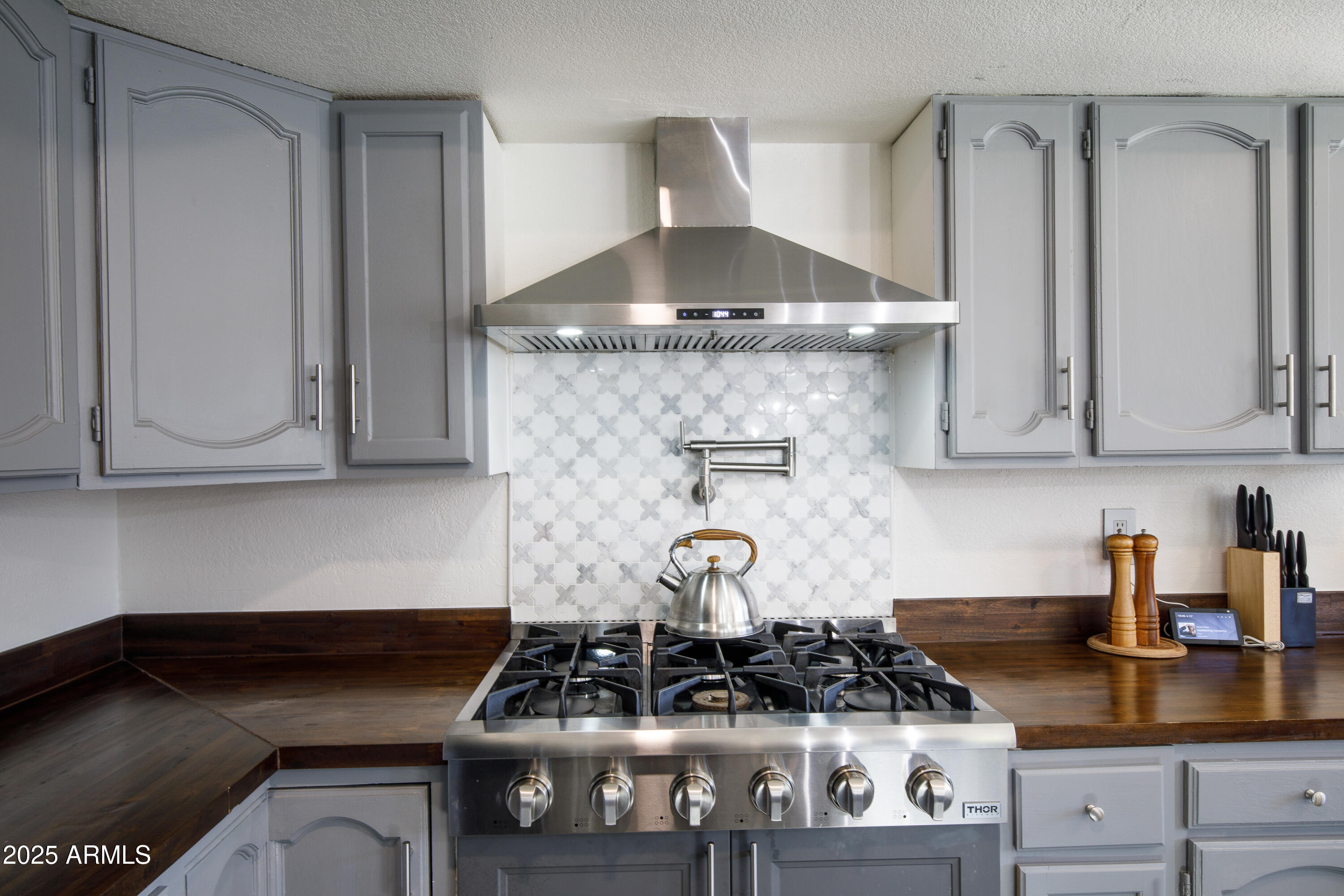 7383 West Utopia Road Glendale, AZ 85308 - Photo 10 of 18 a kitchen with a stove and cabinets