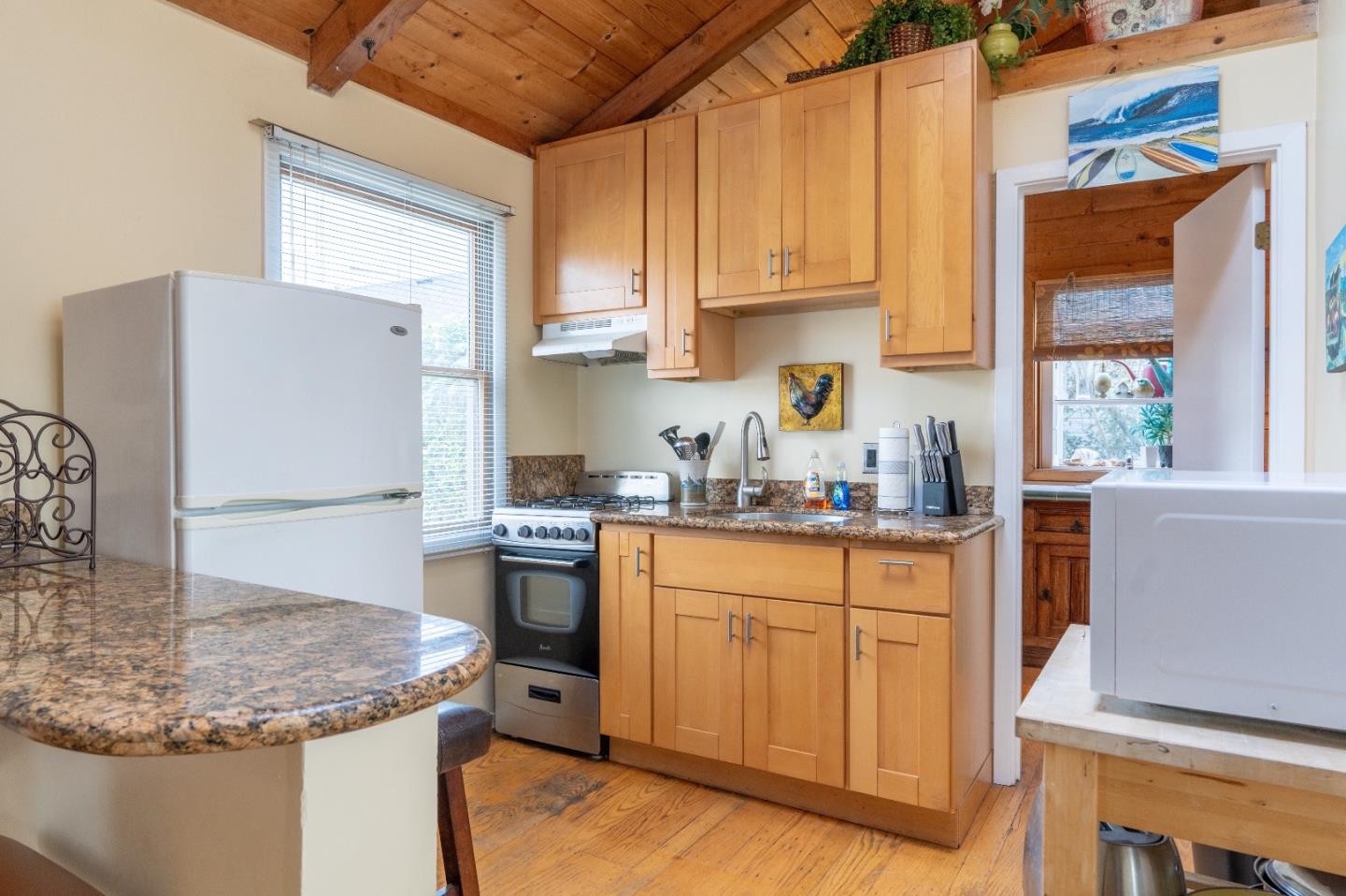 280 Brighton Road Pacifica, CA 94044 - Photo 7 of 12 a kitchen with stainless steel appliances granite countertop a sink dishwasher and cabinets with wooden floor