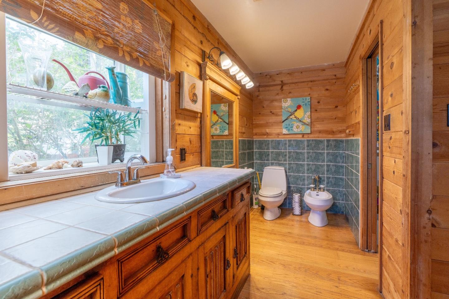 280 Brighton Road Pacifica, CA 94044 - Photo 9 of 12 a bathroom with a granite countertop sink and a large mirror