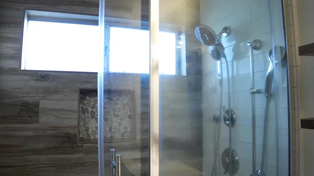 a bathroom with a glass shower door