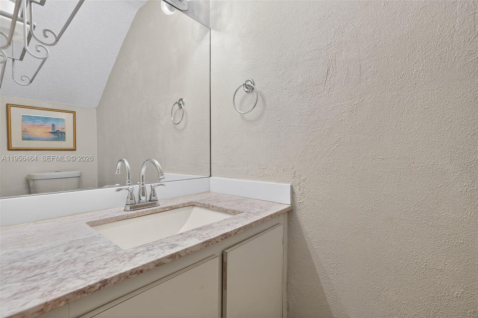 2455 Southwest 11th Street, Unit 7A Miami, FL 33135 - Photo 11 of 38 a bathroom with a granite countertop sink and a mirror