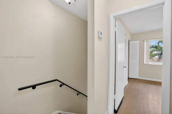a view of an entryway with wooden floor