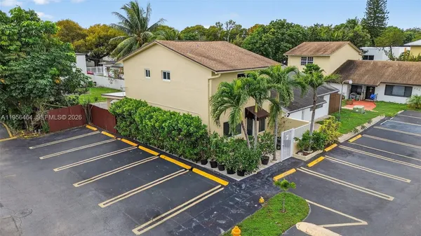 a aerial view of a house with a yard and potted plants