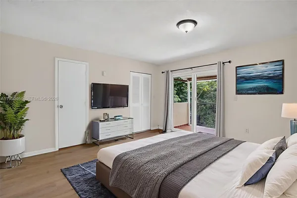 a bedroom with a bed and a potted plant