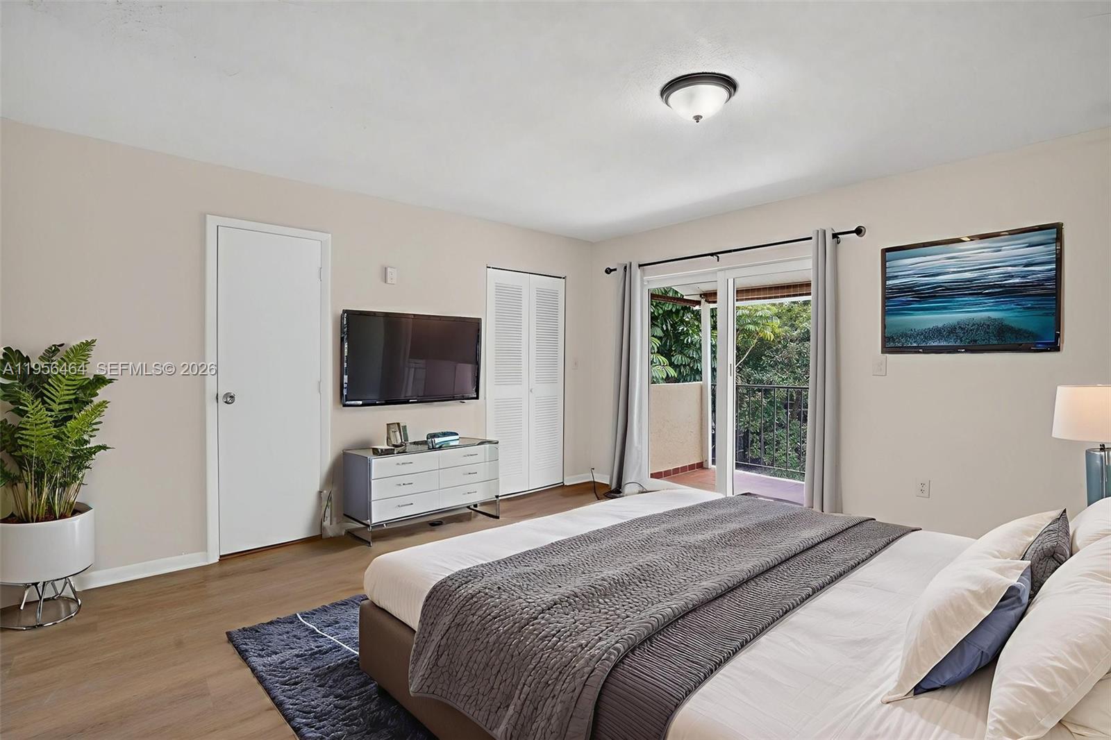 2455 Southwest 11th Street, Unit 7A Miami, FL 33135 - Photo 23 of 38 a bedroom with a bed and a potted plant