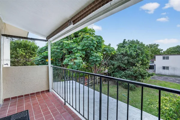 a balcony with trees in front of it