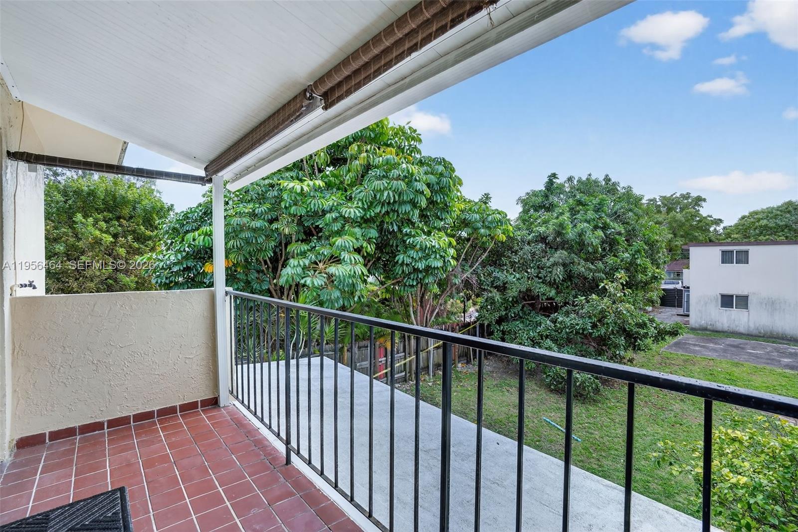 2455 Southwest 11th Street, Unit 7A Miami, FL 33135 - Photo 26 of 38 a balcony with trees in front of it