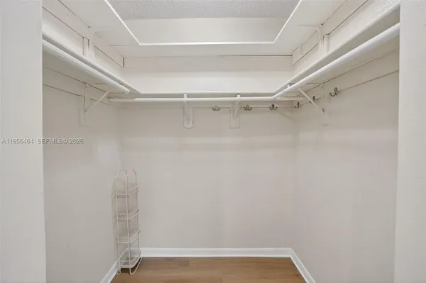 a view of walk in closet with empty racks