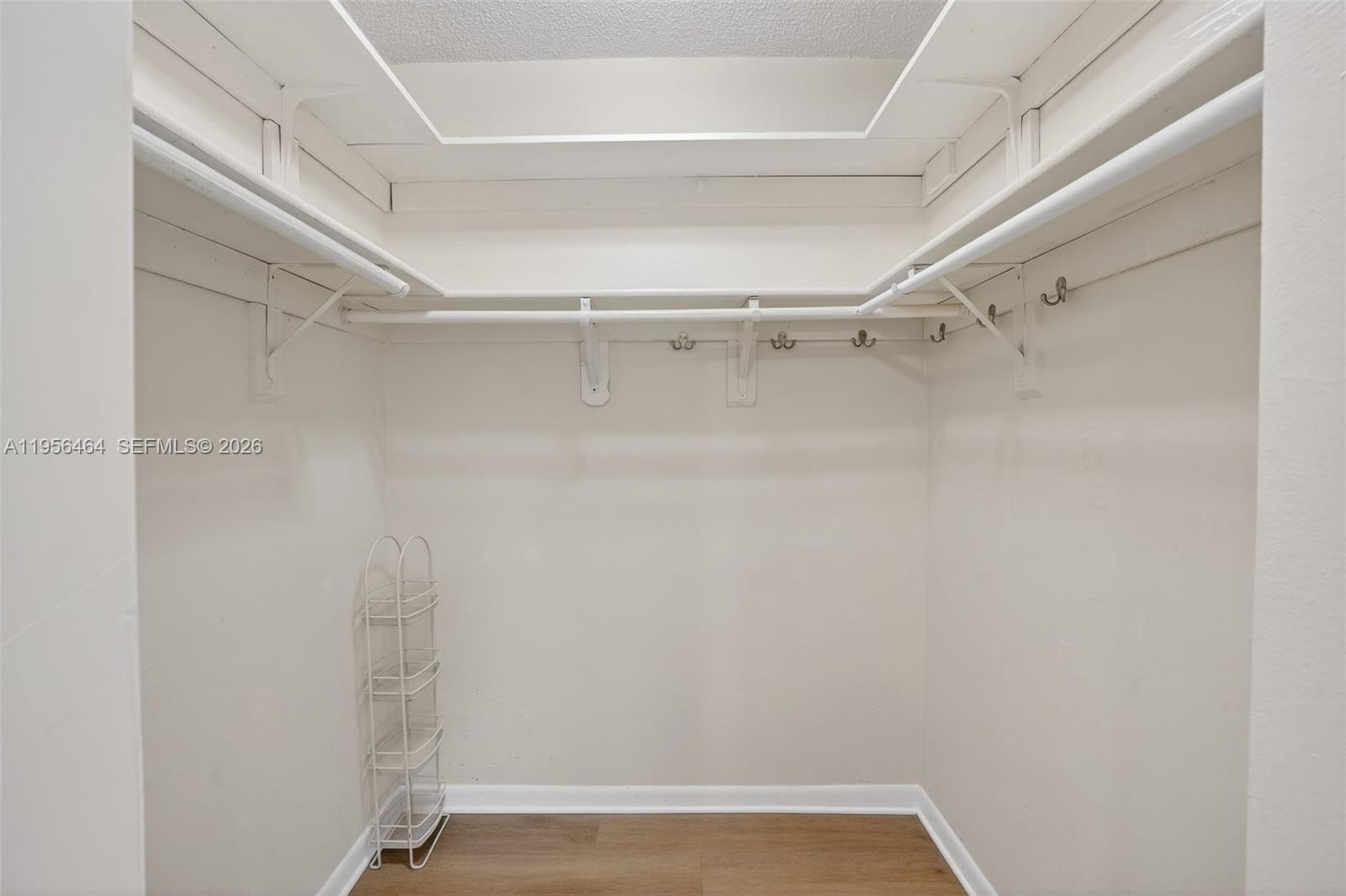 2455 Southwest 11th Street, Unit 7A Miami, FL 33135 - Photo 27 of 38 a view of walk in closet with empty racks
