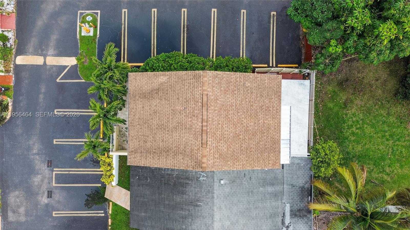 2455 Southwest 11th Street, Unit 7A Miami, FL 33135 - Photo 28 of 38 an aerial view of a house with a yard and large trees