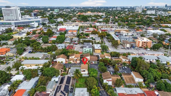 an aerial view of residential houses with city view