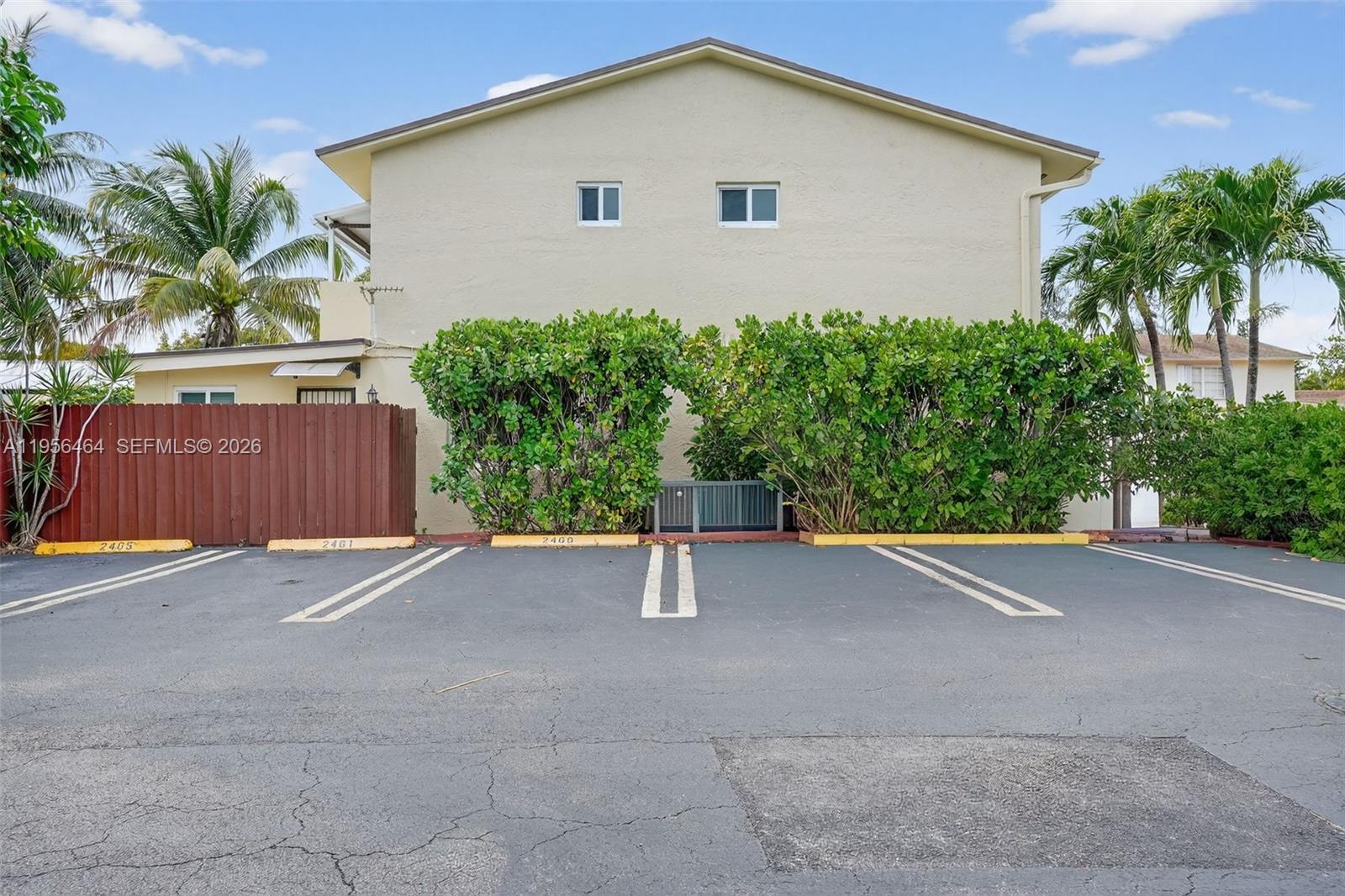 2455 Southwest 11th Street, Unit 7A Miami, FL 33135 - Photo 37 of 38 a house with a yard and wooden fence