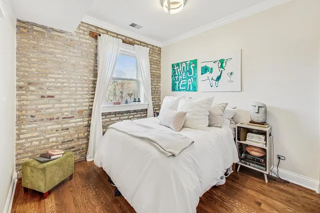 a bedroom with a bed and a painting on the wall