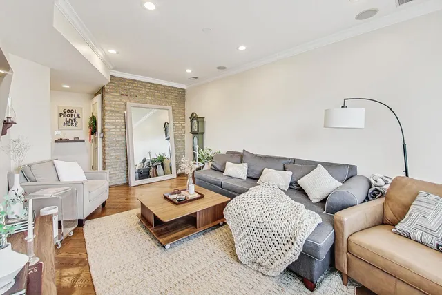 a living room with furniture and wooden floor