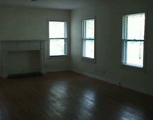 3612 Lawnview Street Corpus Christi, TX 78411 - Photo 5 of 6 an empty room with wooden floor and windows