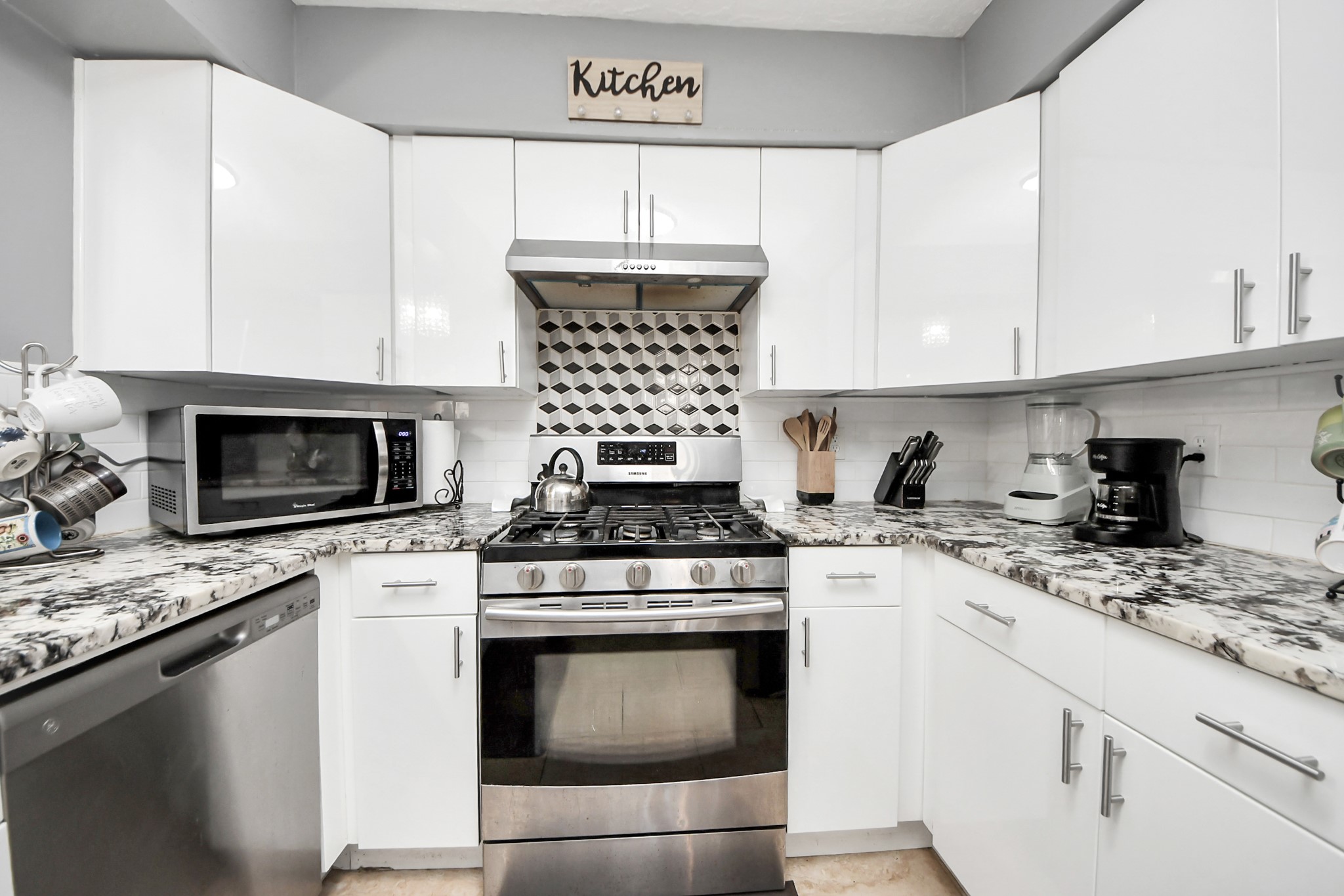 4155 Amir Street Houston, TX 77072 - Photo 23 of 43 a kitchen with granite countertop a stove sink and cabinets