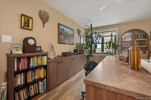 a living room with lots of furniture and a book shelf
