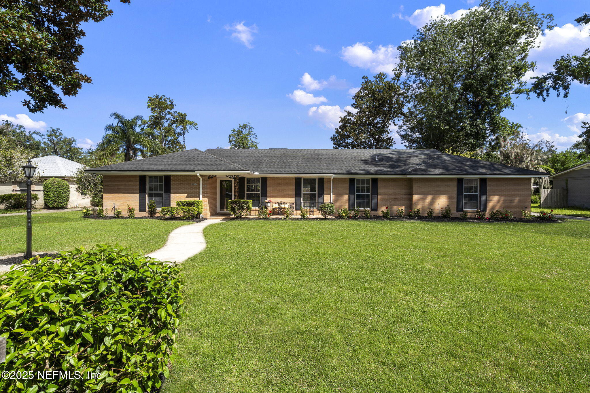 3715 Rustic Lane Jacksonville, FL 32217 - Photo 4 of 45 a front view of a house with a yard table and chairs
