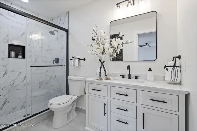 a bathroom with a toilet sink and shower
