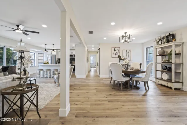 a view of a dining room with furniture and wooden floor