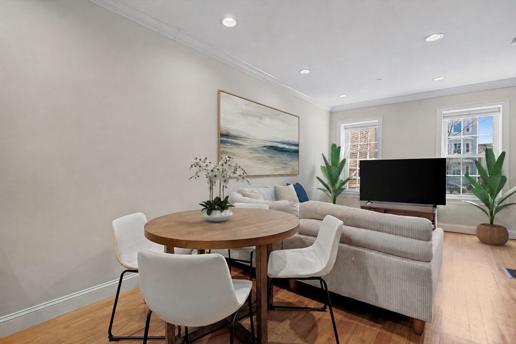 110 Chelsea Street, Unit 1 Boston, MA 02128 - Photo 1 of 12 a living room with furniture and a flat screen tv