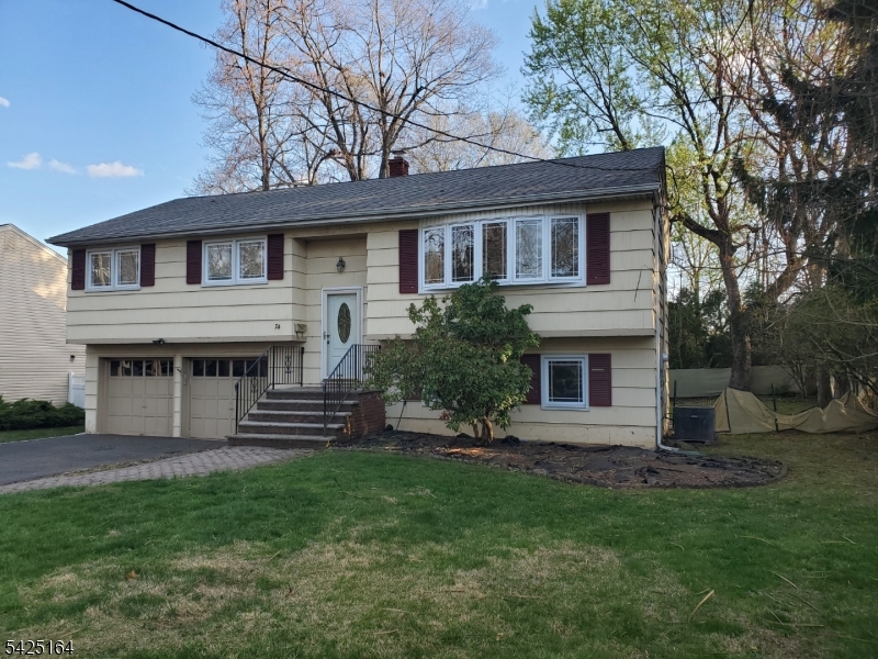 74 East McClellan Avenue Livingston, NJ 07039 - Photo 1 of 7 a front view of a house with a garden