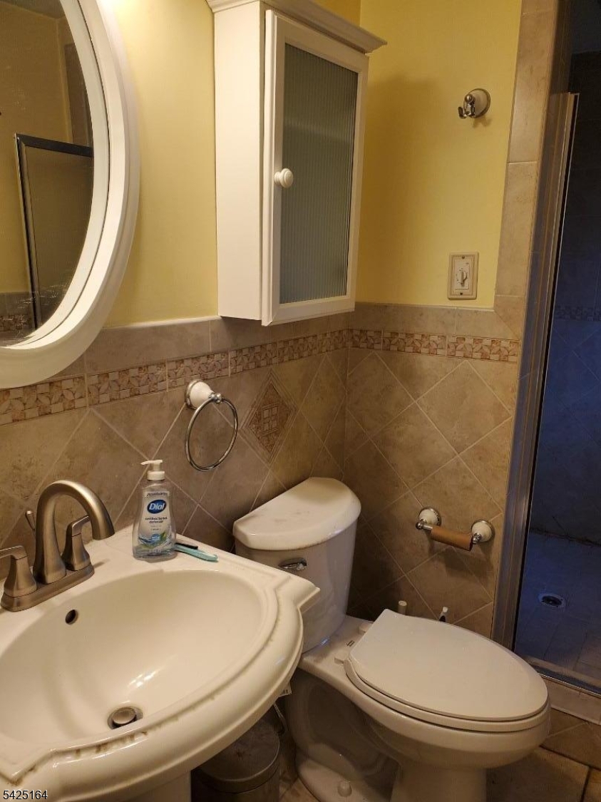 74 East McClellan Avenue Livingston, NJ 07039 - Photo 4 of 7 a bathroom with a toilet and a sink