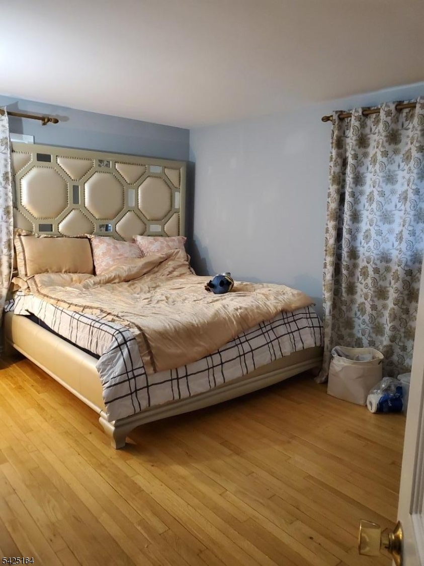 74 East McClellan Avenue Livingston, NJ 07039 - Photo 6 of 7 a large bed sitting in a bedroom next to a small yard