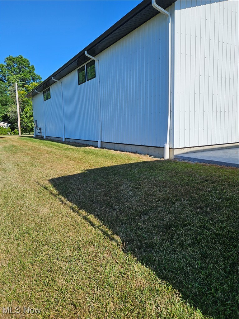 1180 North County Line Road Geneva, OH 44041 - Photo 11 of 33 View of home's exterior featuring a lawn