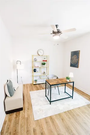 a bedroom with a bed and a dresser with rug