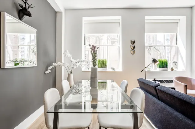 a dining room with furniture and window