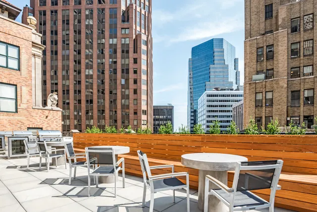 a view of a patio with a table and chairs