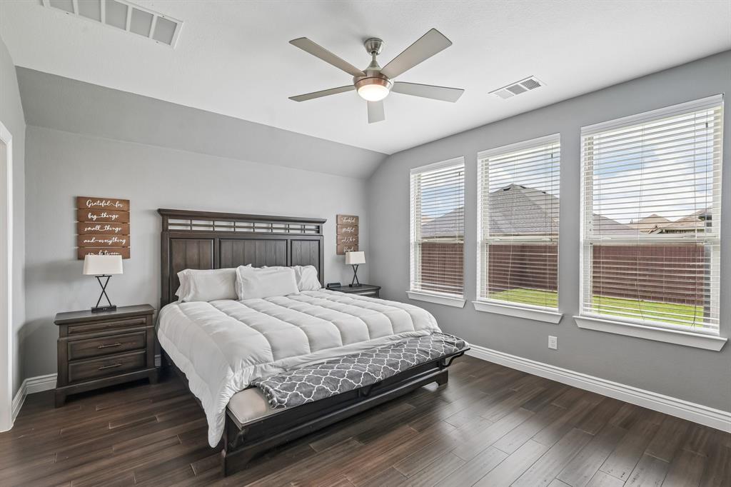 1805 Huntsman Way Forney, TX 75126 - Photo 21 of 34 Bedroom featuring dark wood-finish flooring, light gray wall paint, and white trim