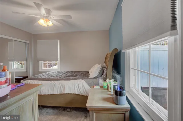 a bedroom with bed and a chandelier