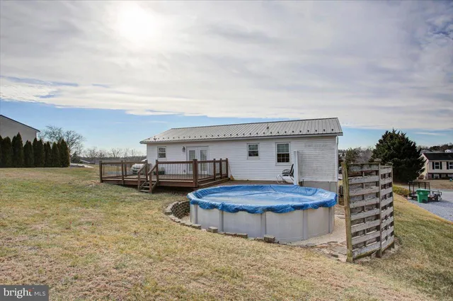 a view of a house with backyard and sitting area