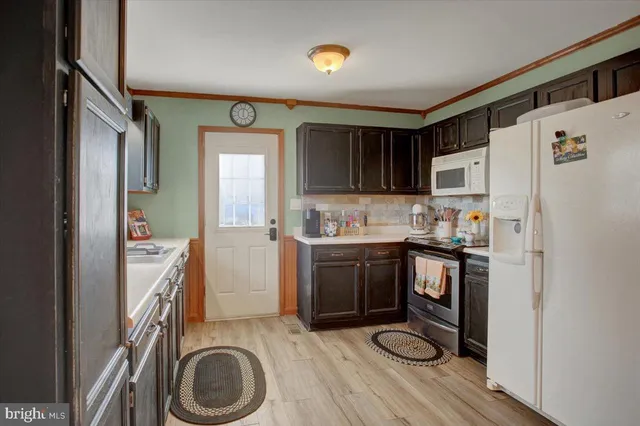 a kitchen with a refrigerator sink and stove