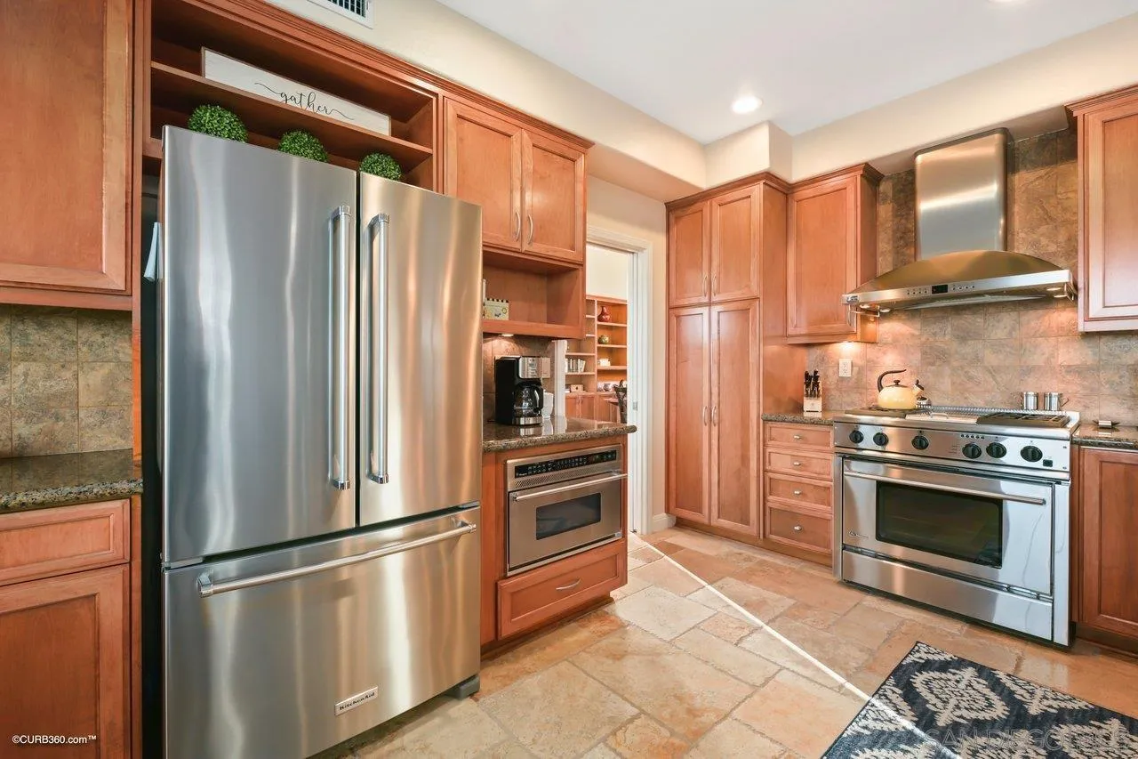 12504 Eclipse Place San Diego, CA 92129 - Photo 24 of 60 a kitchen with stainless steel appliances granite countertop a refrigerator stove and a sink