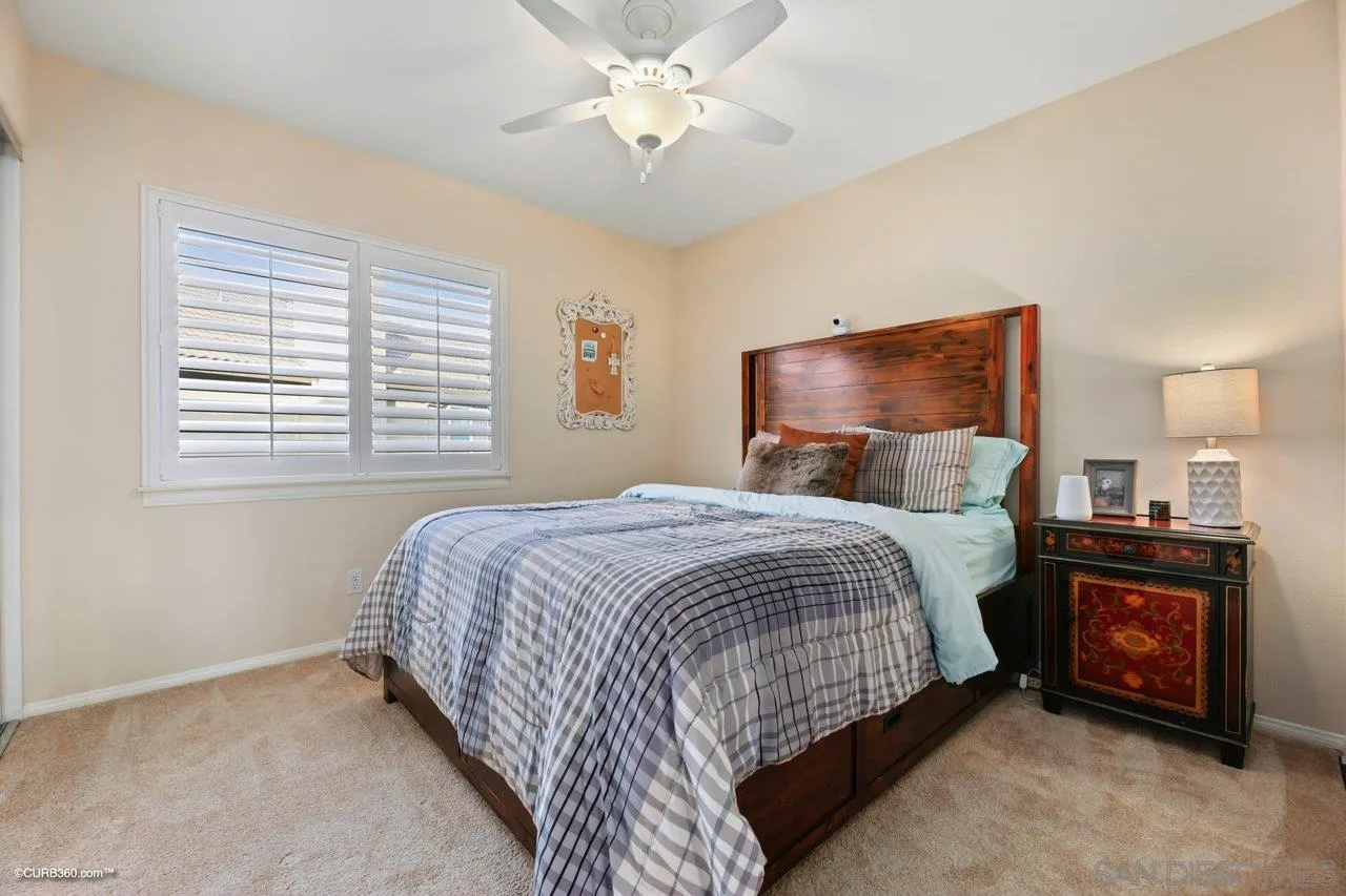 12504 Eclipse Place San Diego, CA 92129 - Photo 37 of 60 a bedroom with a bed and a fireplace