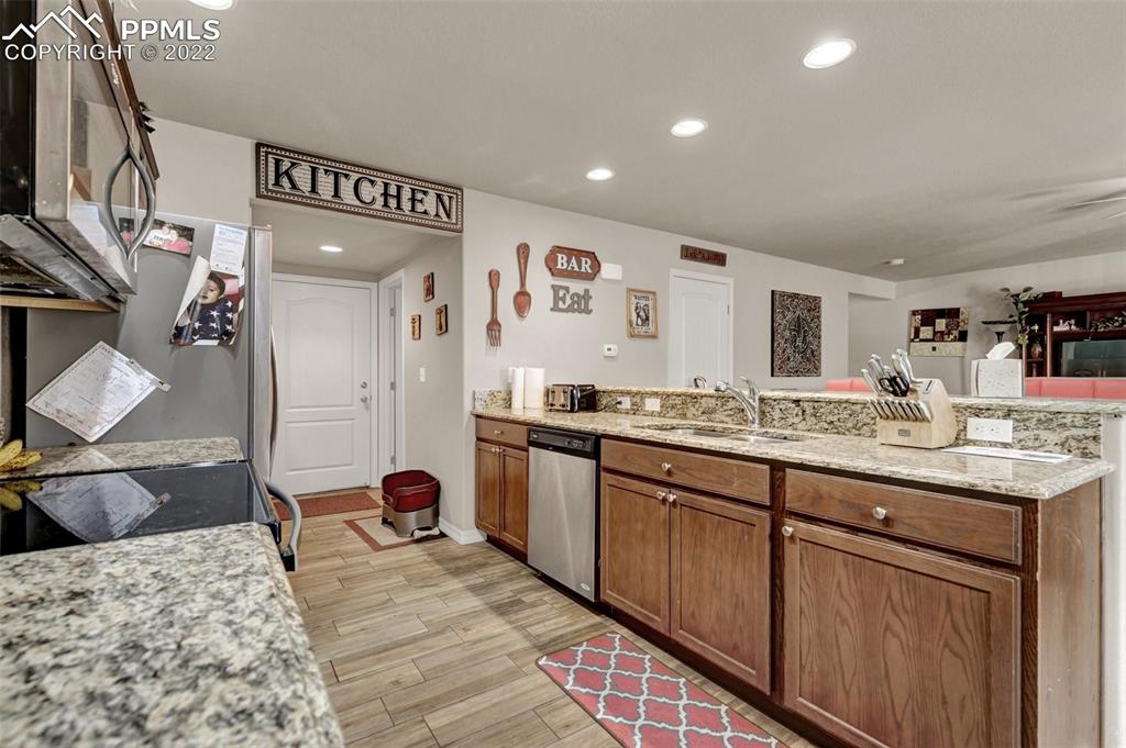 6570 Gelbvieh Road Peyton, CO 80831 - Photo 16 of 38 a spacious bathroom with a granite countertop sink a mirror and shower