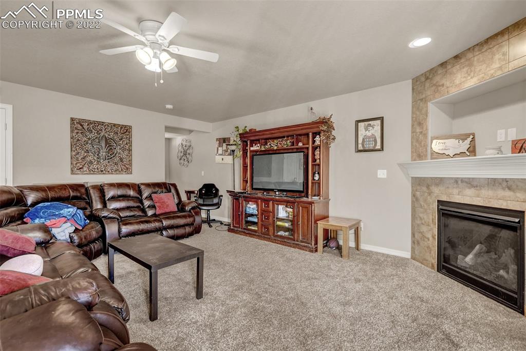 6570 Gelbvieh Road Peyton, CO 80831 - Photo 6 of 38 a living room with furniture and a fireplace