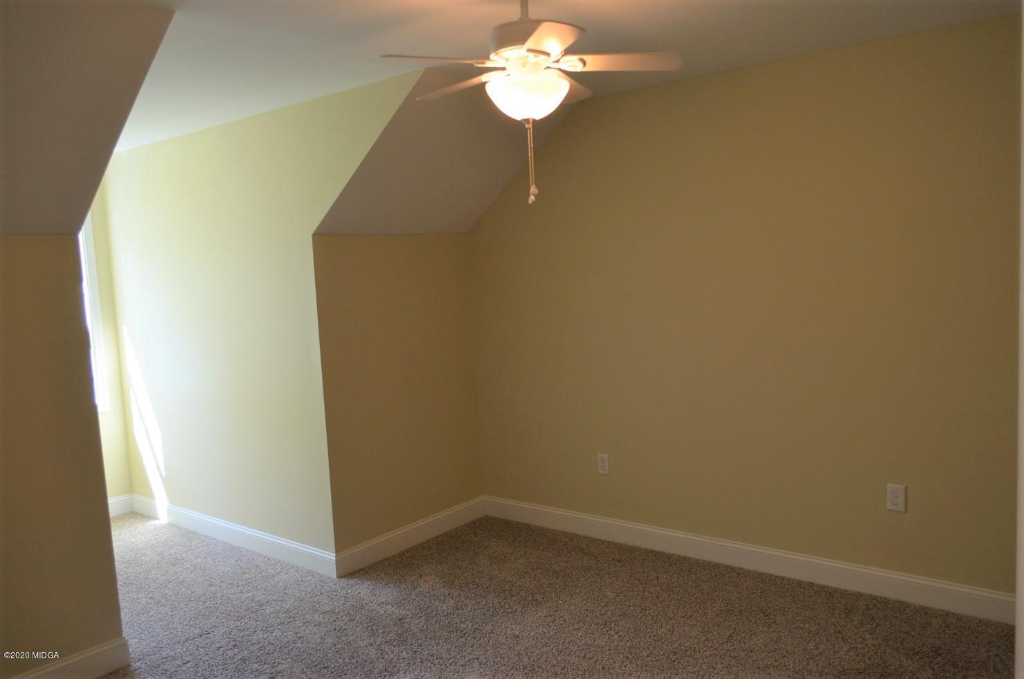 253 Chadwick Circle Macon, GA 31210 - Photo 14 of 19 an empty room with a chandelier fan