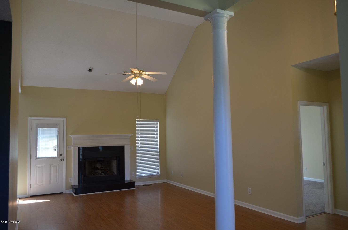 253 Chadwick Circle Macon, GA 31210 - Photo 4 of 19 a view of an empty room with wooden floor and a fireplace