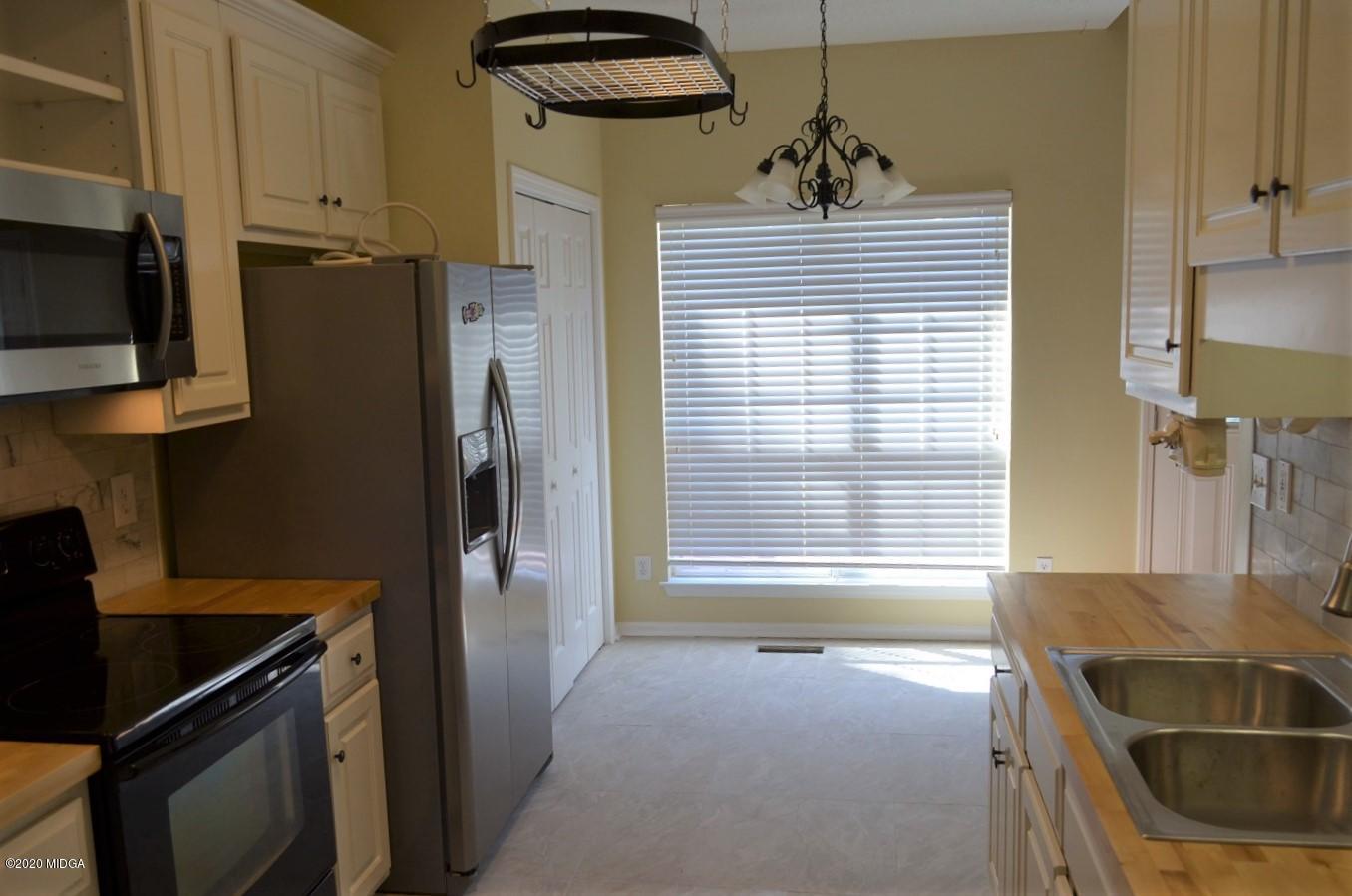 253 Chadwick Circle Macon, GA 31210 - Photo 8 of 19 a kitchen with a refrigerator and a sink