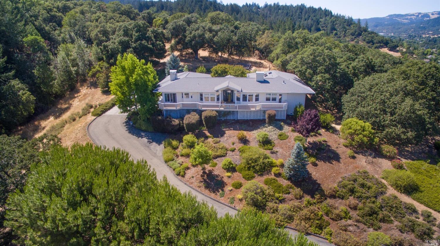 a view of a house with a yard and a wooden fence