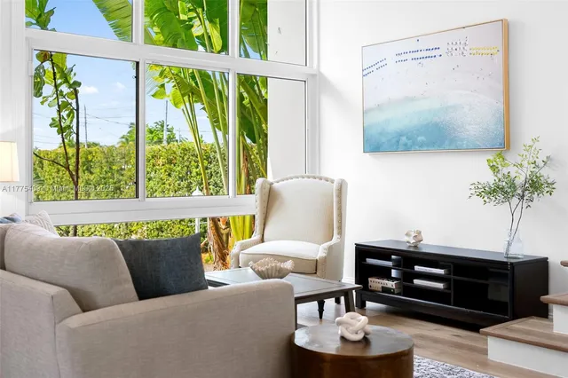 a living room with furniture and a potted plant